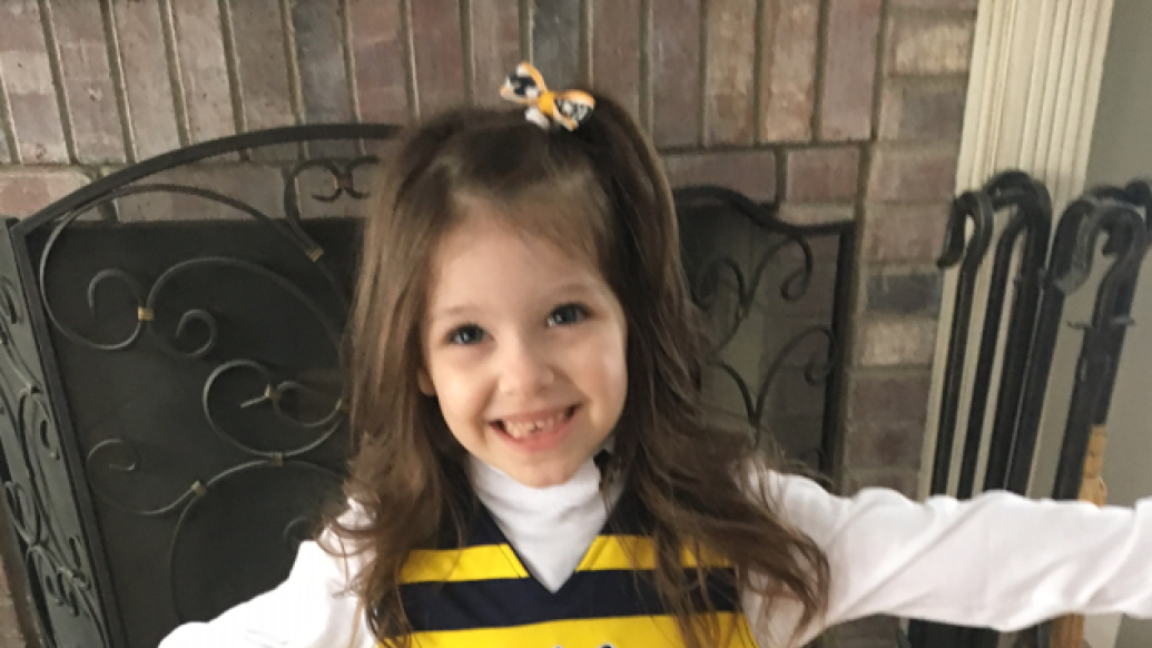 Young Blaire smiles for a photo in her Michigan outfit 