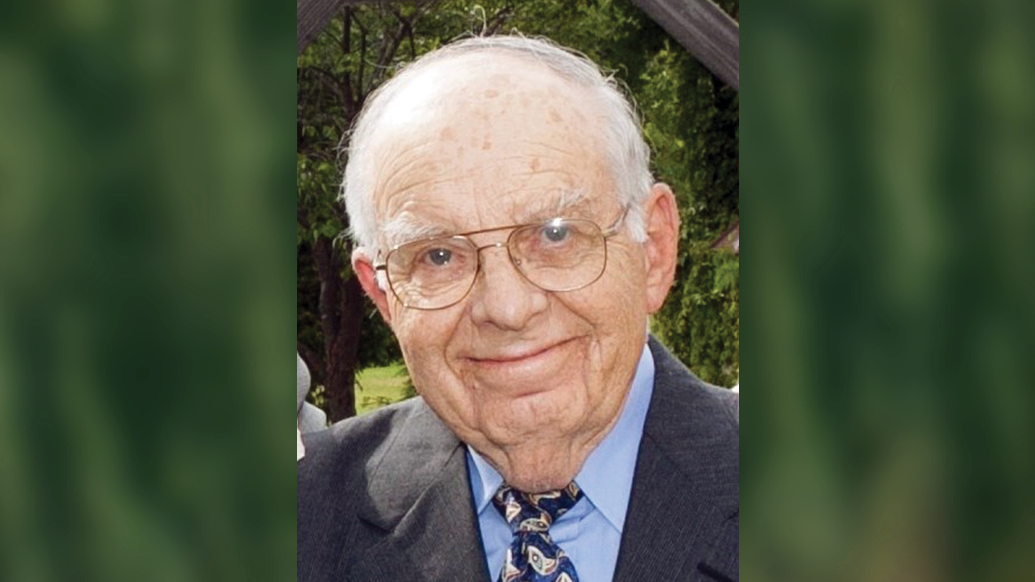 portrait of an older man wearing glasses and slightly smiling