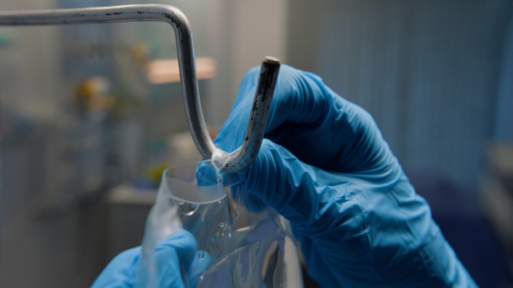 blue gloves in hospital hanging IV bag