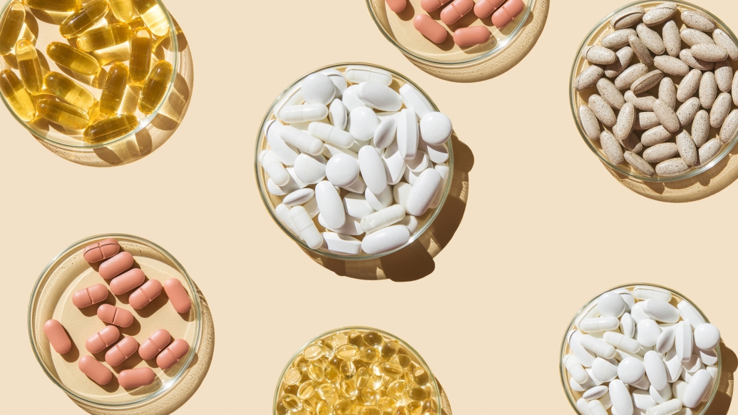 different color pills yellow pink white tan in small glass bowls on peach background