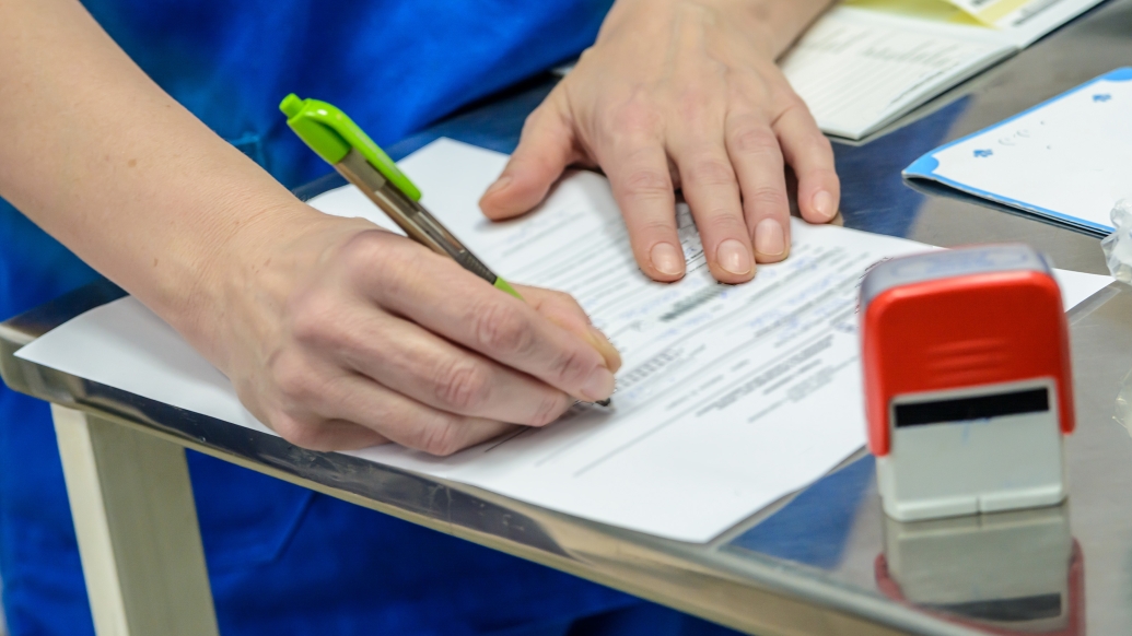 hands on paper writing with a pen