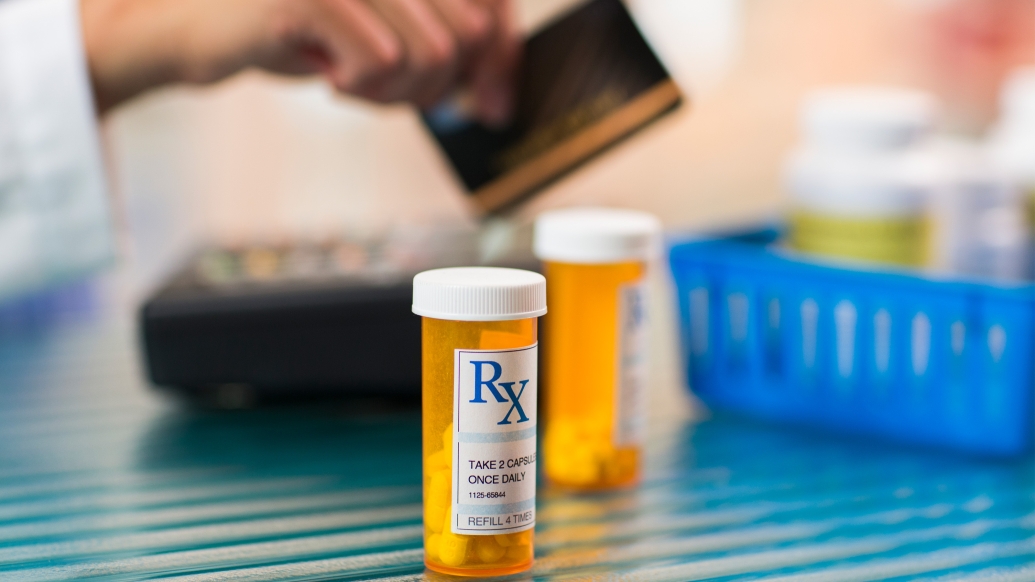 rx bottle orange see through person paying in background