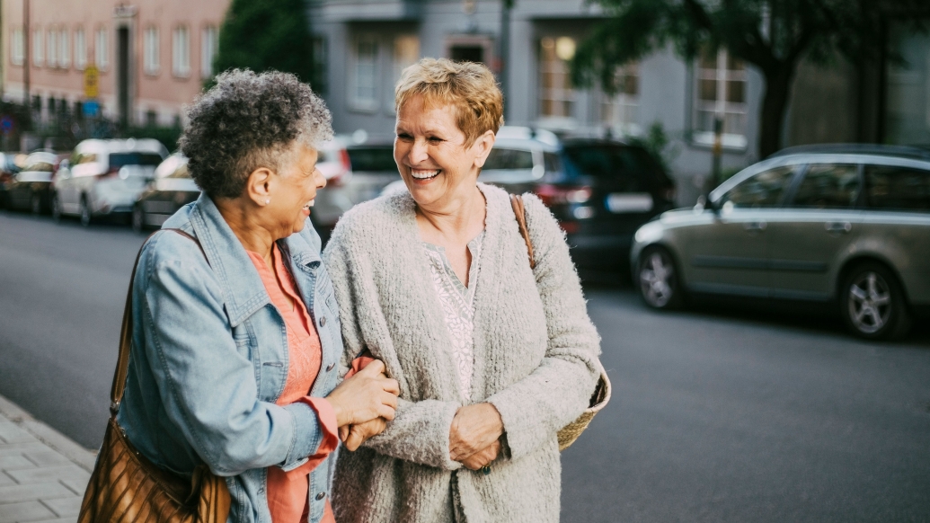 friends talking outside older walking smiling