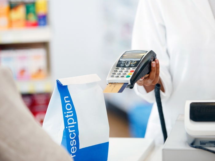 counter with credit card machine and white bag 