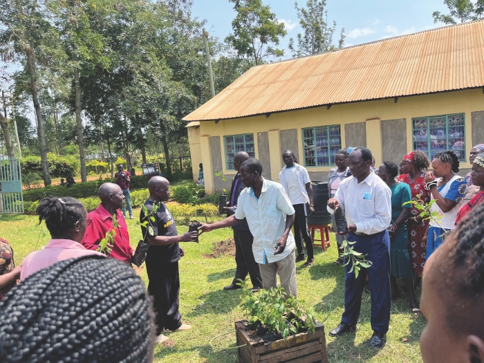 Members of Eco2librium, a company specializing in sustainable energy and forestry, distributed tree seedlings to a community in Busia County, Kenya, during a site visit.