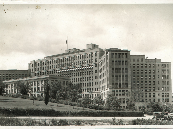 Black and white image of University Hospital in 1933. The 8 or 10 story building, called "Old Main," was designed by Albert Kahn.