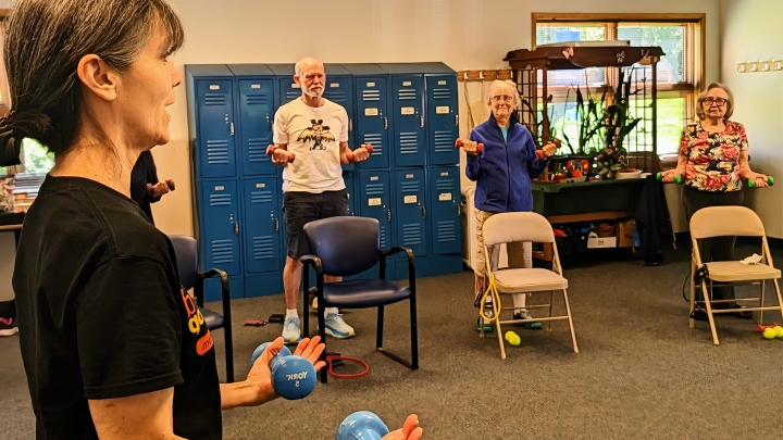 Turner Senior Wellness participants lift weights during class