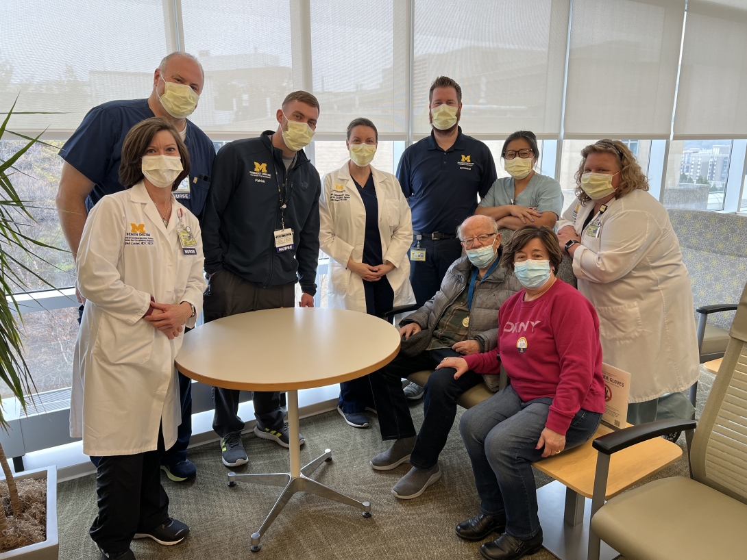 Staff with masks on around table