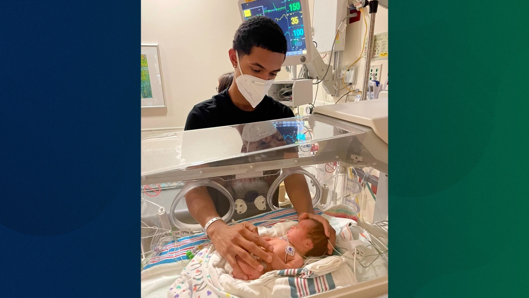 dad with baby in NICU