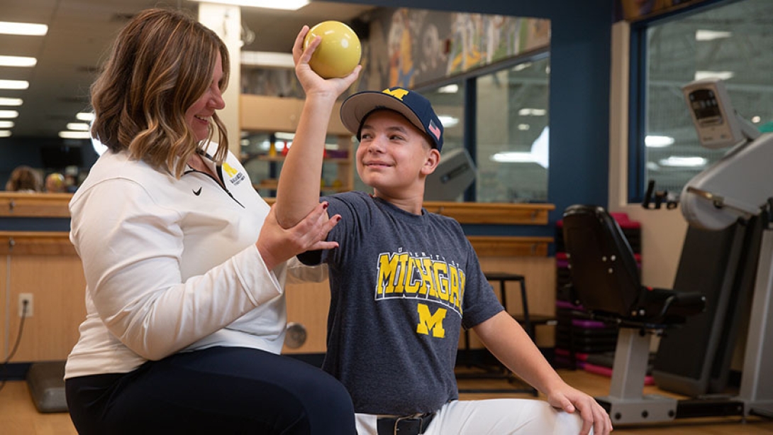 therapist helping preteen with arm