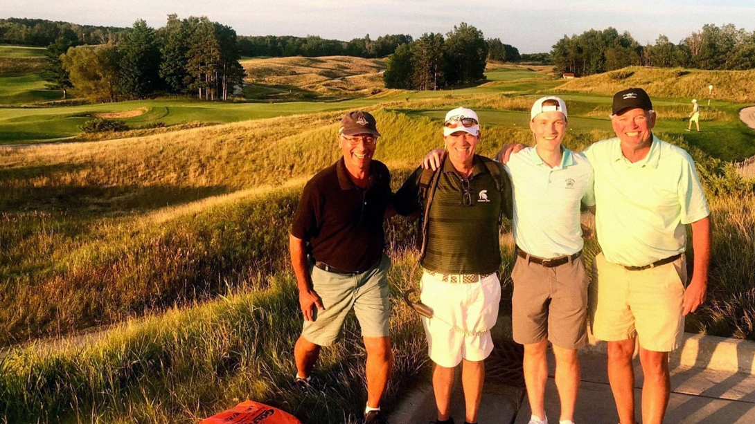 McVeigh family members pose and smile on a golf course