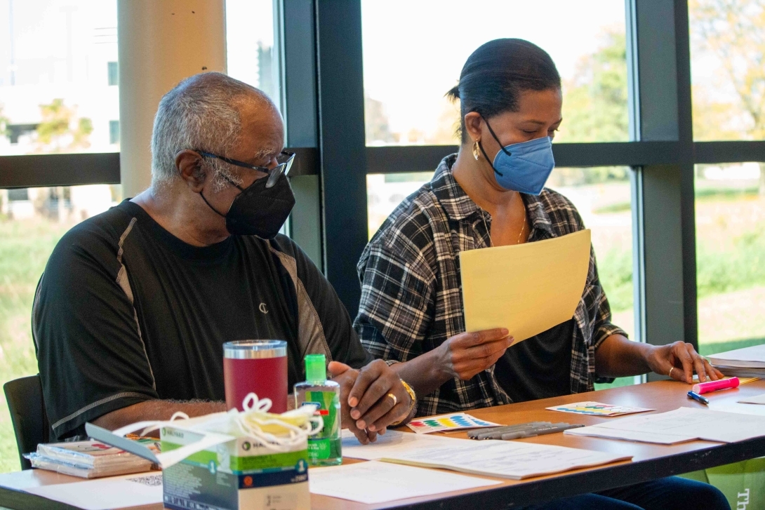 non-clinical flu clinic volunteers work at the table