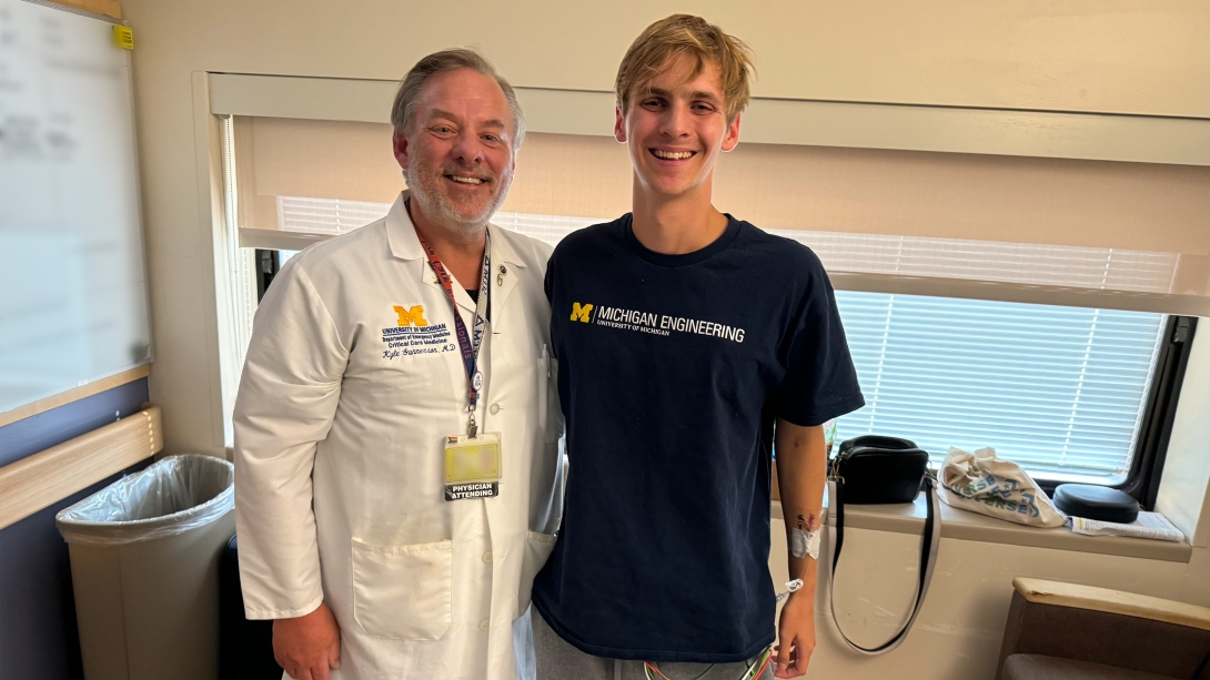 doctor and young adult man standing smiling together at camera