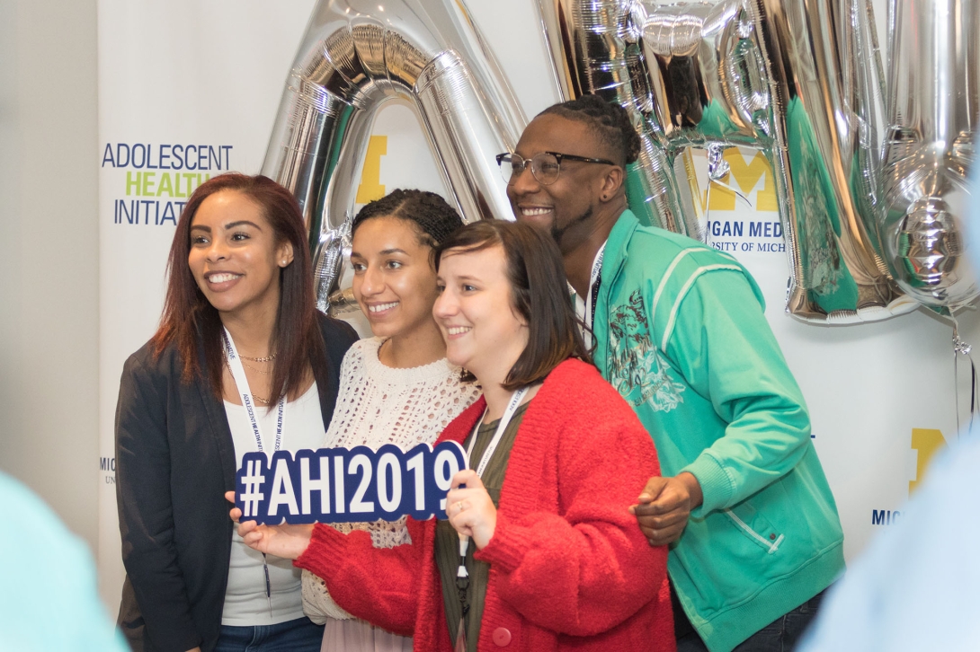 Small group smiles for photo at 2019 conference