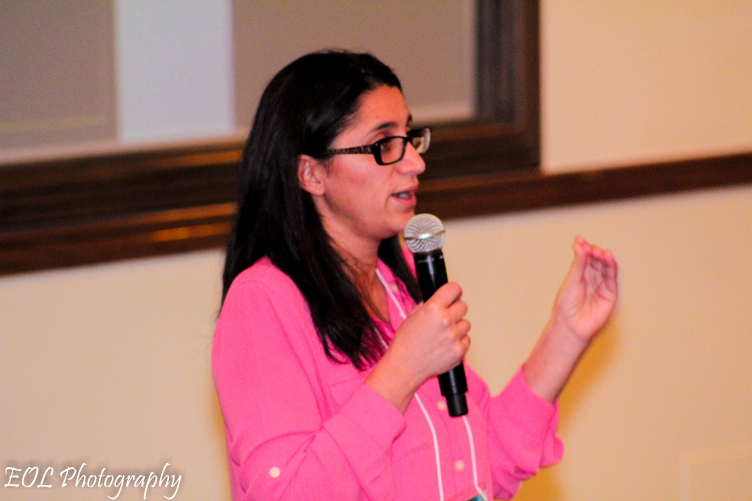 female speaker holds microphone during presentation