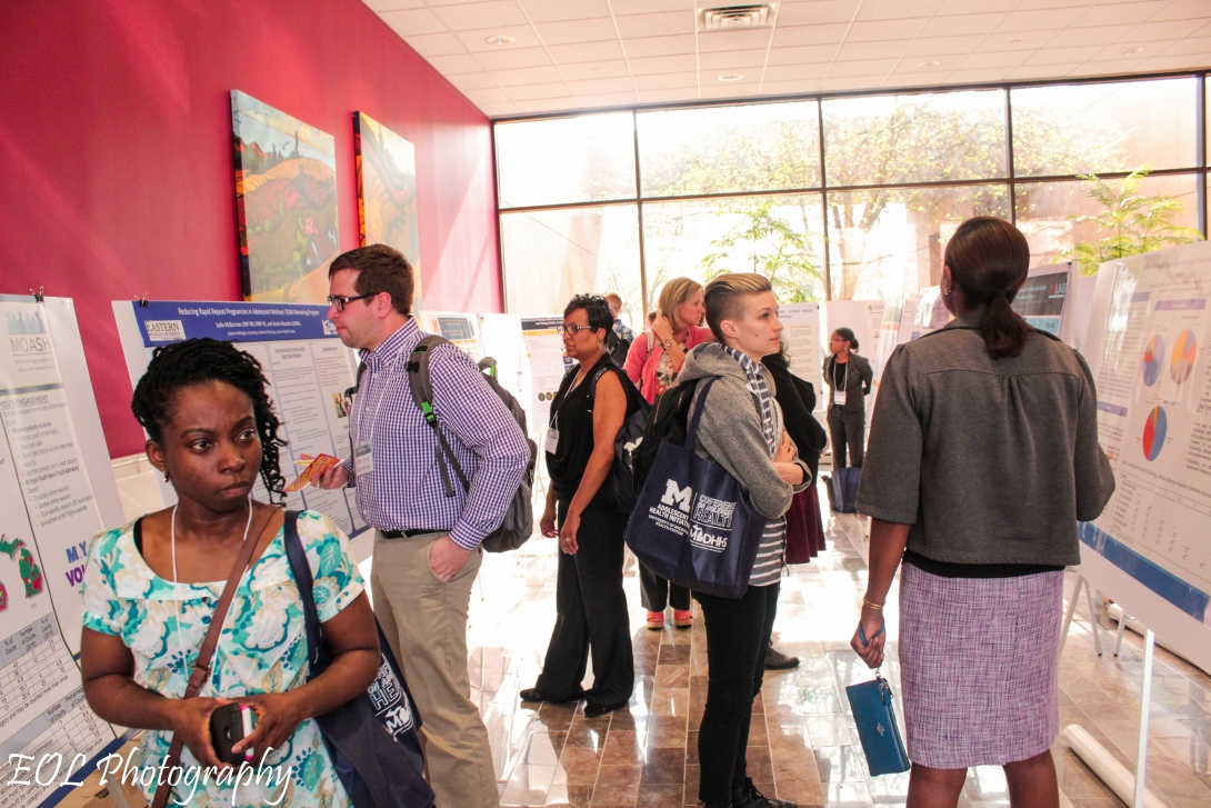 Conference attendees browse posters 